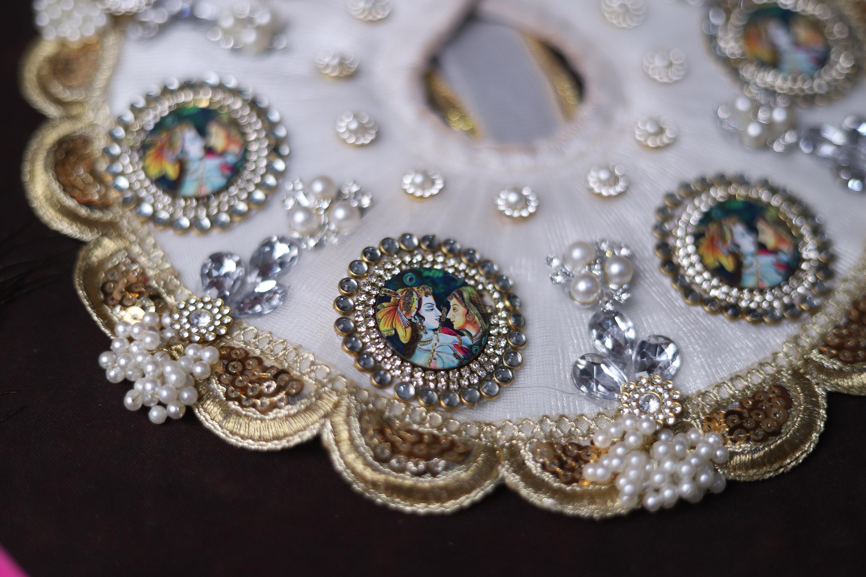 White Shrinathji Embroidered Laddu Gopal Dress with Elegant Golden Ruffled Lace Border Janmashtami and Festive Puja Wear